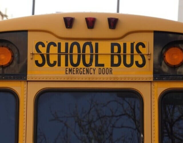 The back of a yellow school bus