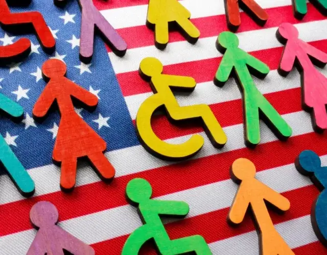 multi-colored stick people with disabilities on top of the American Flag.