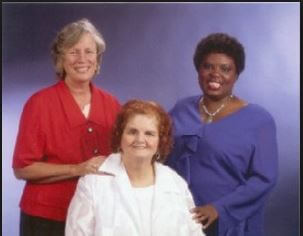 Sue, Lois and Elaine, the three women representing the Olmstead decision pose in red, white and blue.